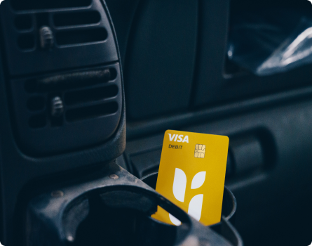 Bushel Debit Card Sitting In Vehicle Cupholder